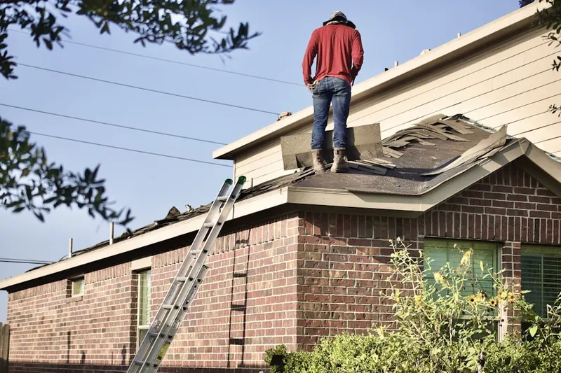 Professional roofer working on a residential roof in Follen Heights